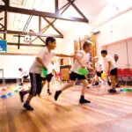 Children playing in a school hall gym