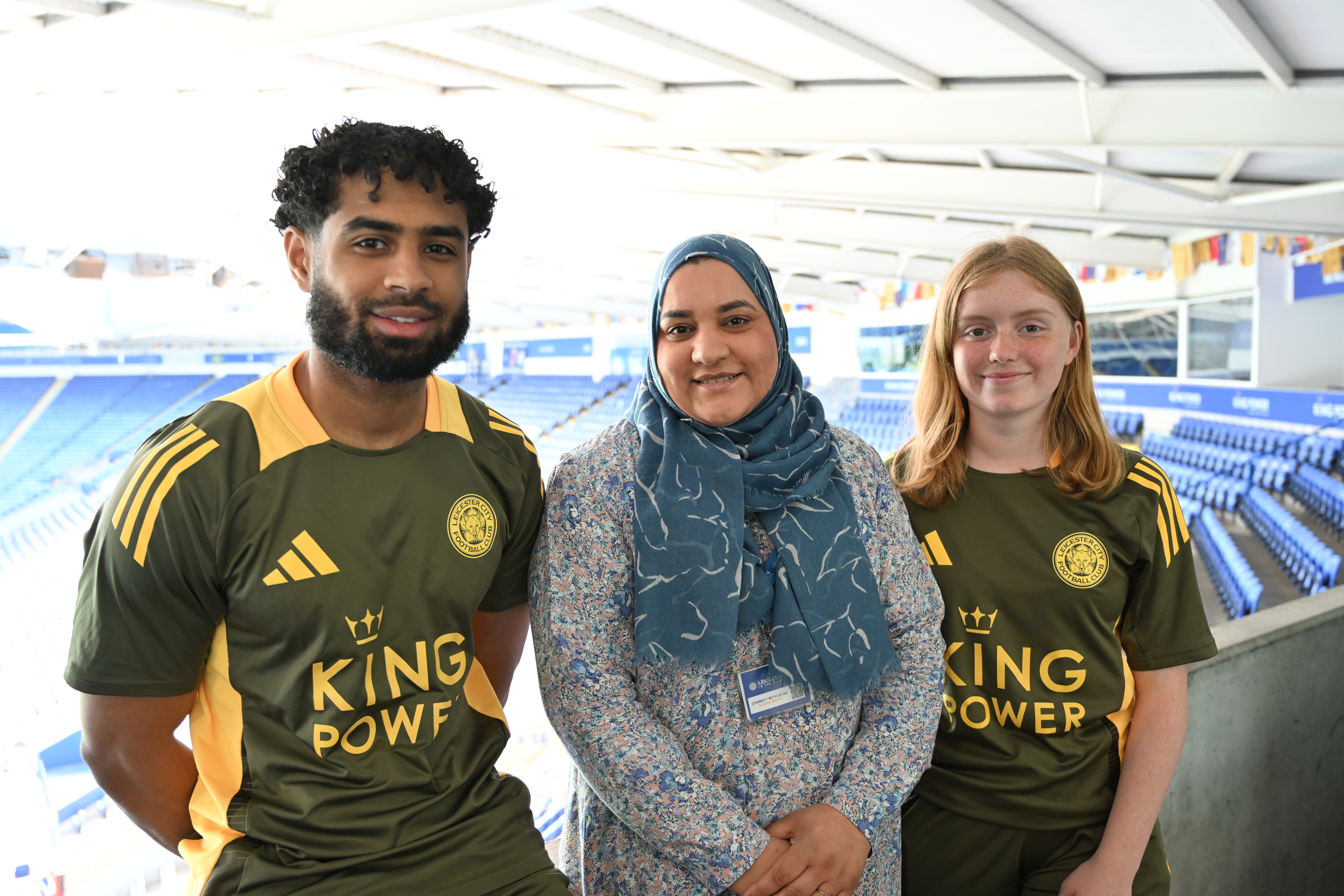 Three Leicester City in the Community staff standing in stadium