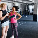 Female personal trainer showing the gym to the new member