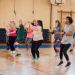 Group of people doing keep fit in a sports hall