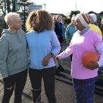 Group of older women talking after playing netball