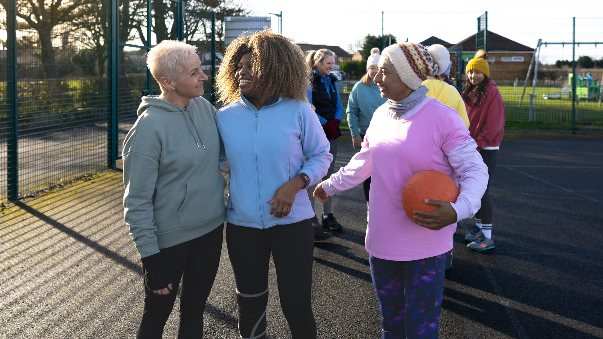 Group of older women talking after playing netball