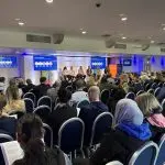 A panel session takes place on stage at the CIMSPA conference