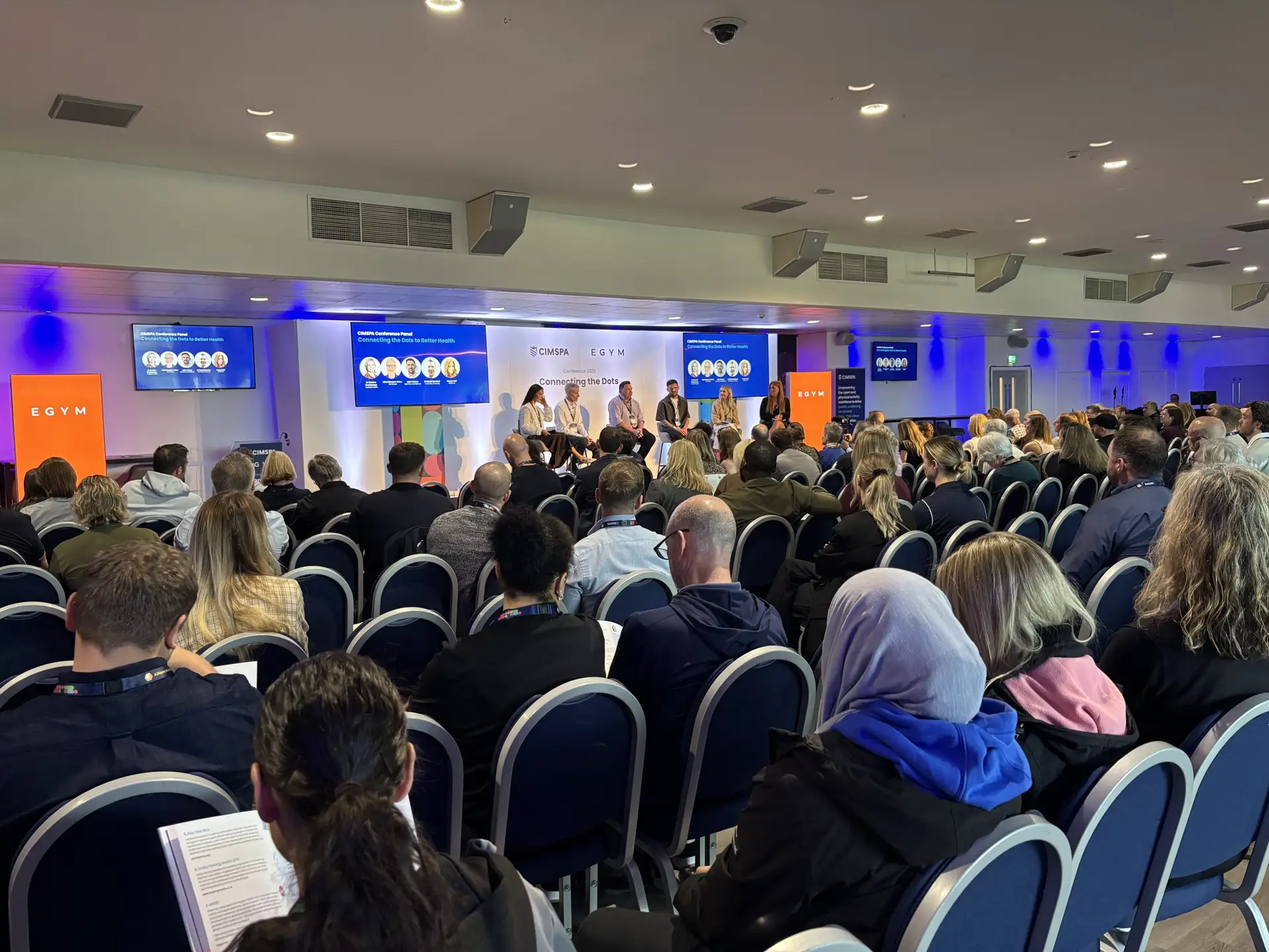 A panel session takes place on stage at the CIMSPA conference