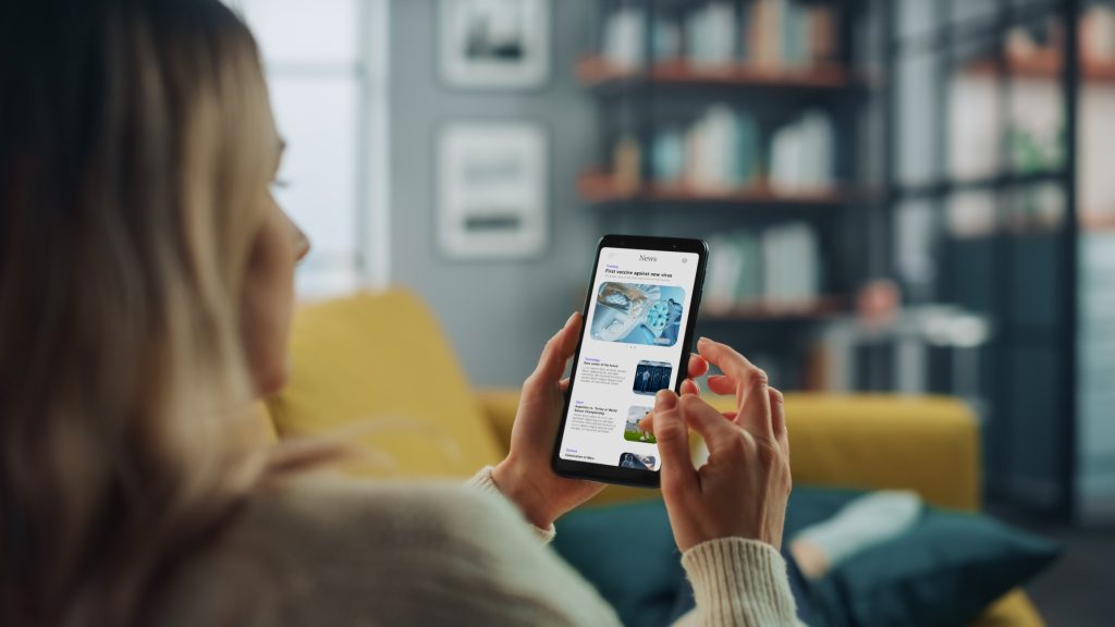 A woman reads news on her phone