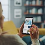 A woman reads news on her phone