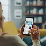 A woman reads news on her phone