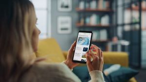 A woman reads news on her phone