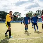 A referee blows the whistle during a football match