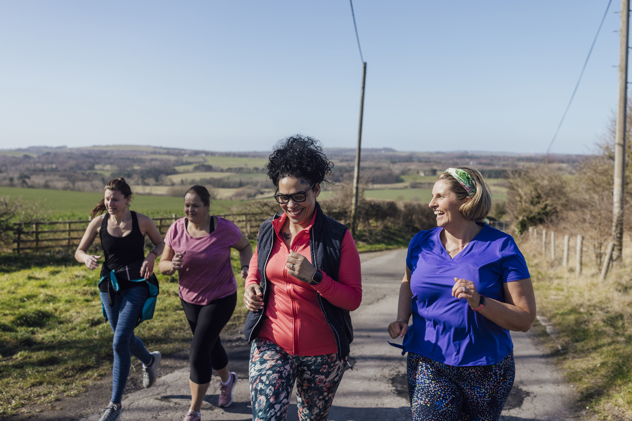 A group of women run in the countryside