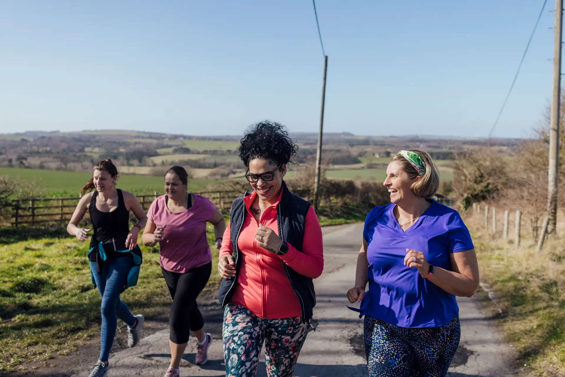 A group of women run in the countryside