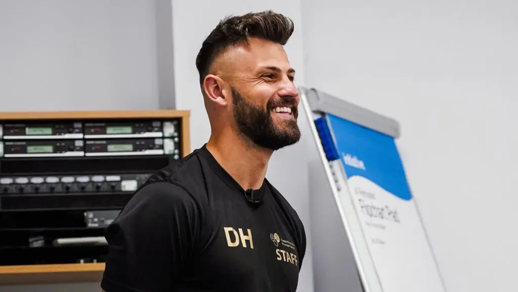 Dan Hancock's head and shoulders, looking to the side and smiling