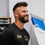 Dan Hancock's head and shoulders, looking to the side and smiling