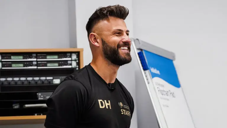 Dan Hancock's head and shoulders, looking to the side and smiling