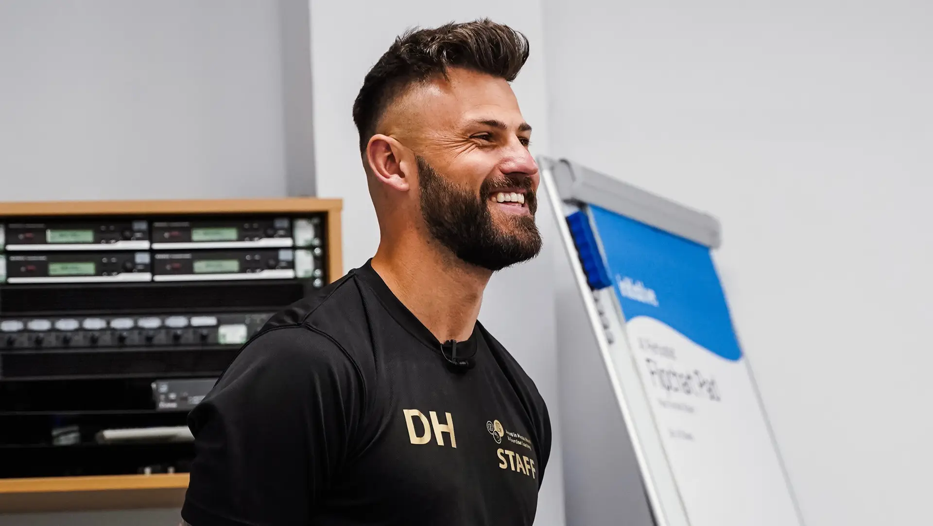 Dan Hancock's head and shoulders, looking to the side and smiling