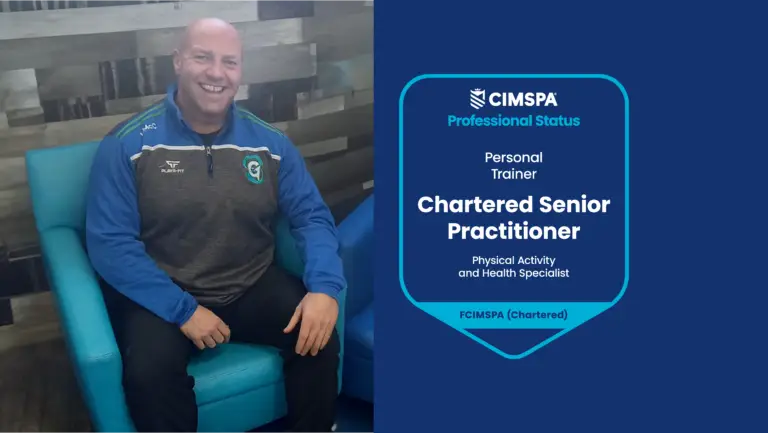 Liam sitting in a chair smiling at the camera. To the right is his professional status credential.