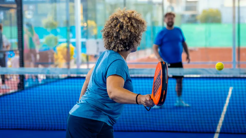 A woman plays padel