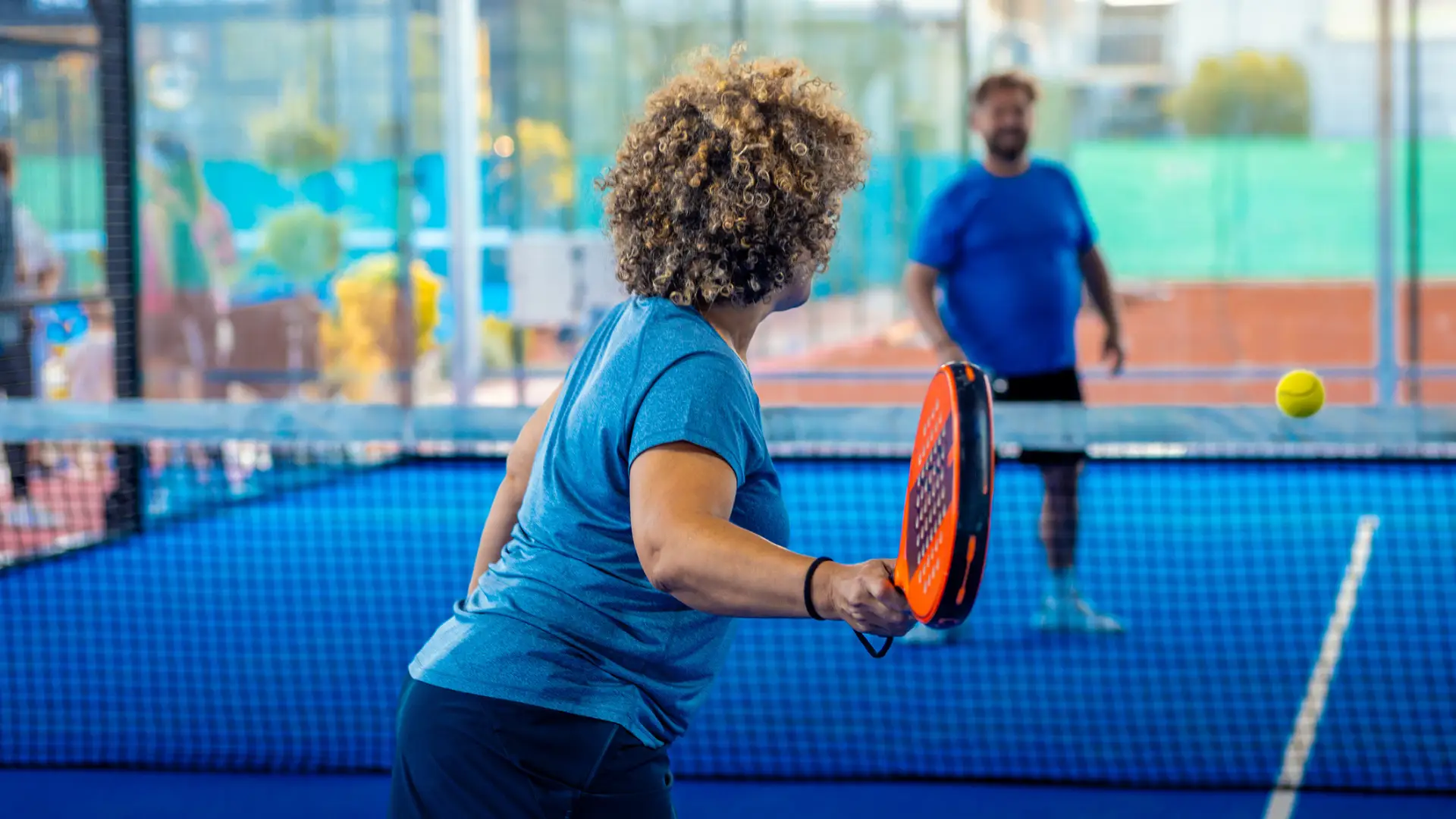 A woman plays padel