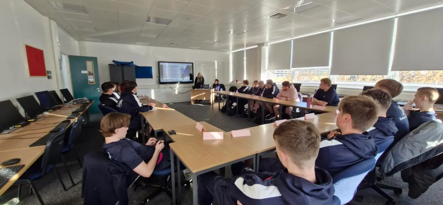 Students sit in a classroom watching a presentation