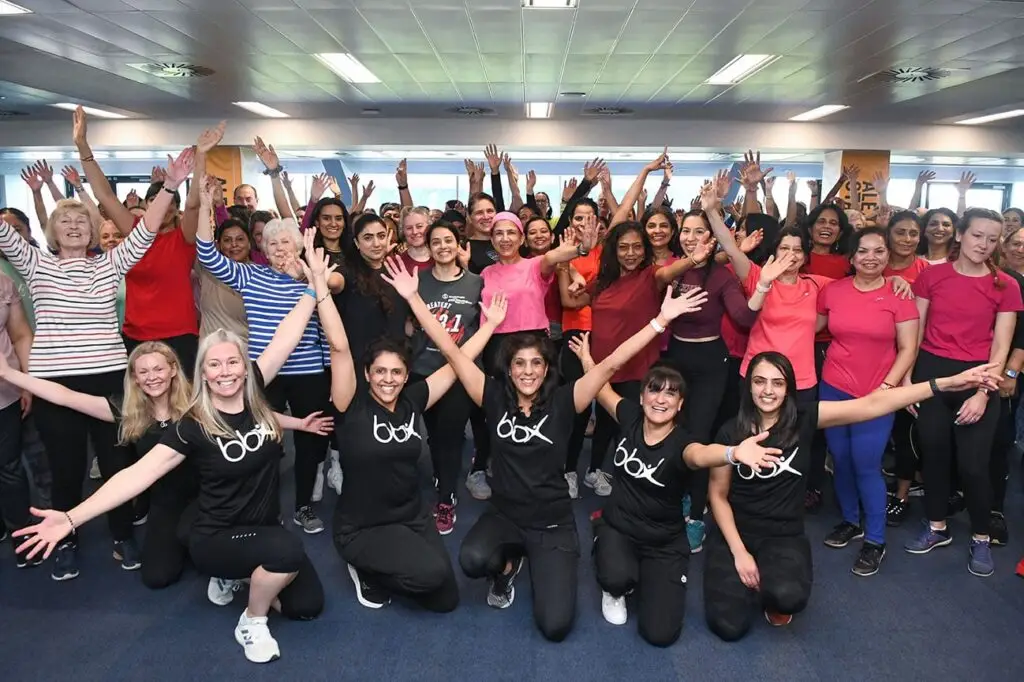 A large group posing for a photo after a BBX Fitness class.
