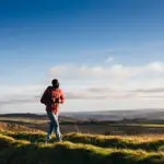 One young adult walking on Hadrian's Wall in Northumberland, UK countryside.