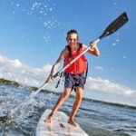 A young boy paddleboarding