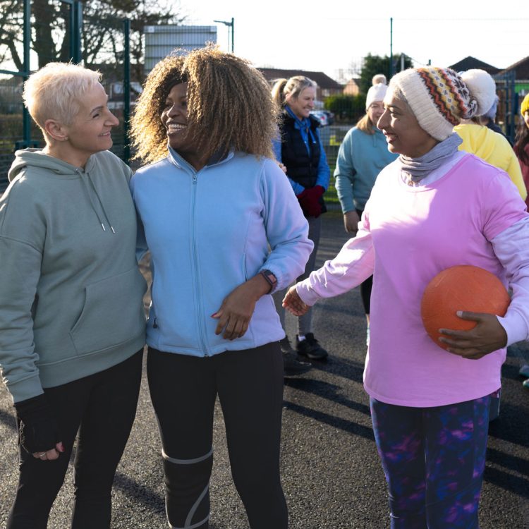 Group of older women talking after playing netball