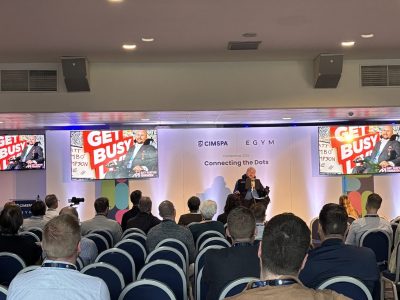 Matt Hampson speaks on stage at the CIMSPA conference