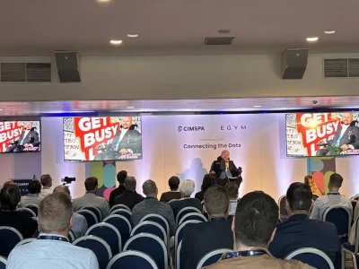 Matt Hampson speaks on stage at the CIMSPA conference