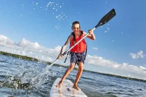 A young boy paddleboarding